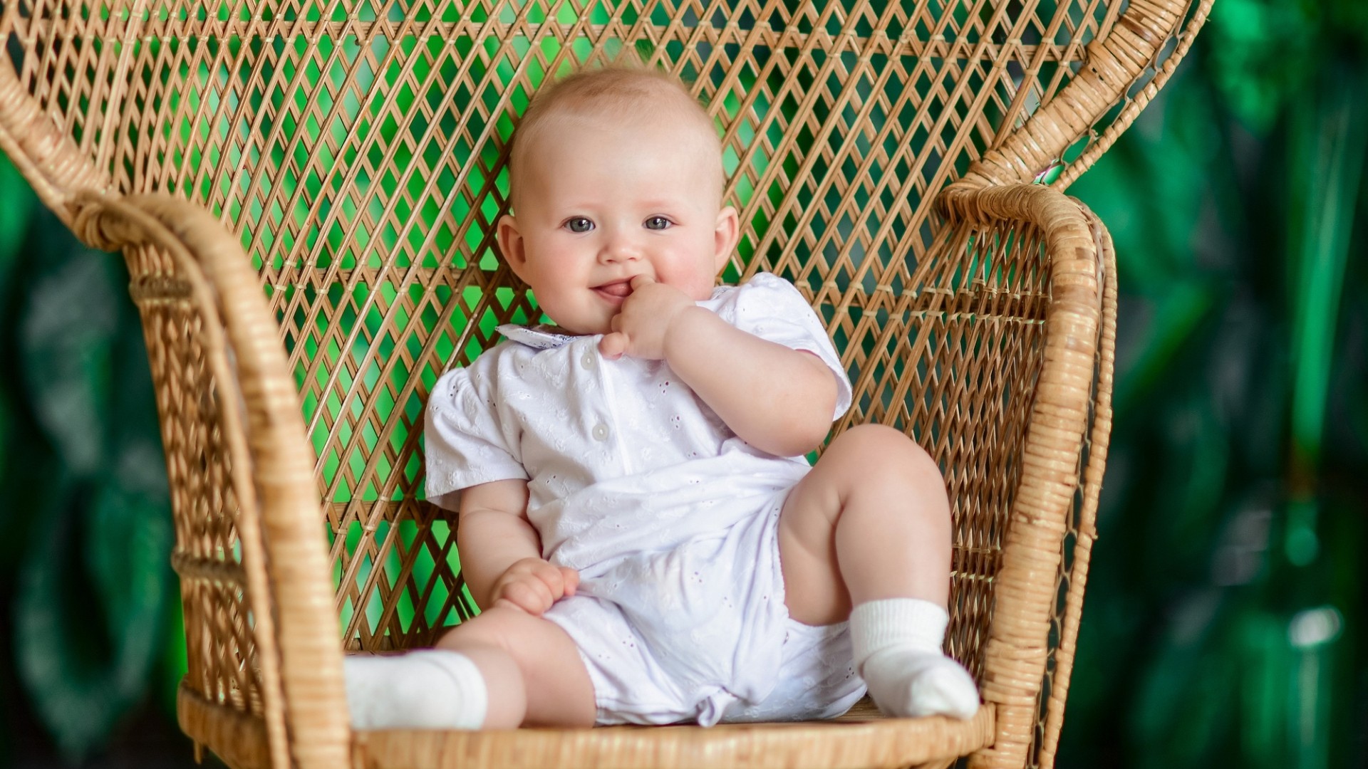 Cute baby girl sitting on wood chair